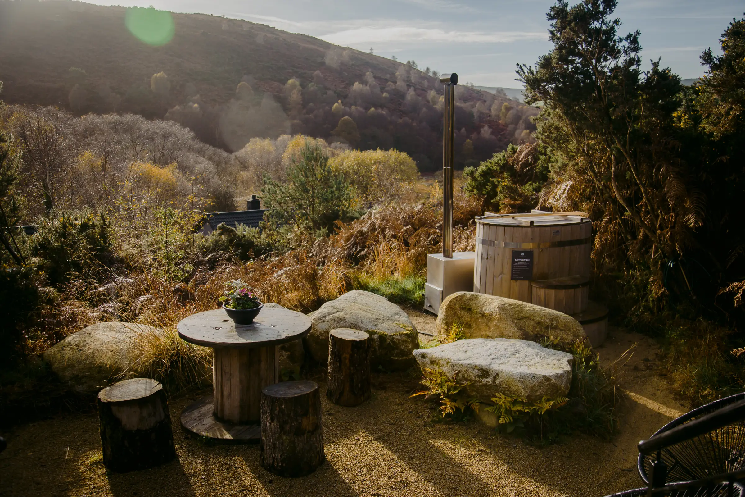 The Deerstone grounds with a wood-fired tub and the Wicklow hills beyond