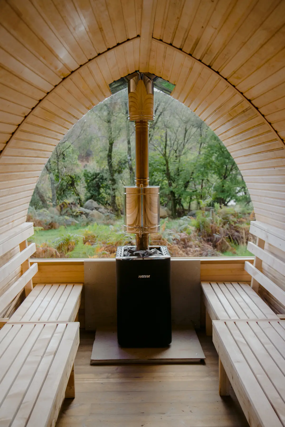 Inside the wooden sauna with a forest view